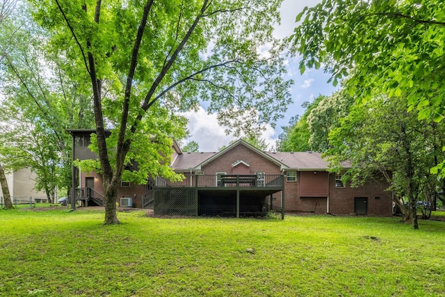 2520 Johnson Ridge Rd, Antioch, TN 37013 - rear view of property with a deck, brick siding, a yard, and central AC