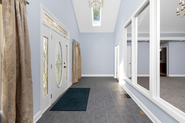 2520 Johnson Ridge Rd, Antioch, TN 37013 - foyer with a chandelier, dark tile patterned flooring, a skylight, baseboards, and vaulted ceiling