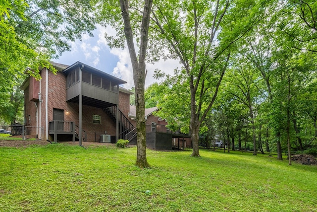 2520 Johnson Ridge Rd, Antioch, TN 37013 - view of grassy yard featuring a sunroom, central AC unit, and stairway