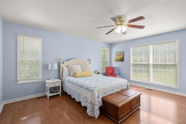 4291 Skelley Rd, Santa Fe, TN 38482 - bedroom featuring baseboards, wood finished floors, multiple windows, and a ceiling fan