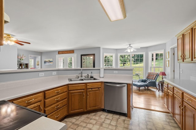 4291 Skelley Rd, Santa Fe, TN 38482 - kitchen with stainless steel dishwasher, a ceiling fan, a sink, and brown cabinetry