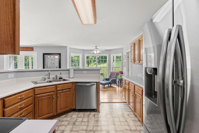 4291 Skelley Rd, Santa Fe, TN 38482 - kitchen featuring stainless steel appliances, a sink, brown cabinets, and light countertops