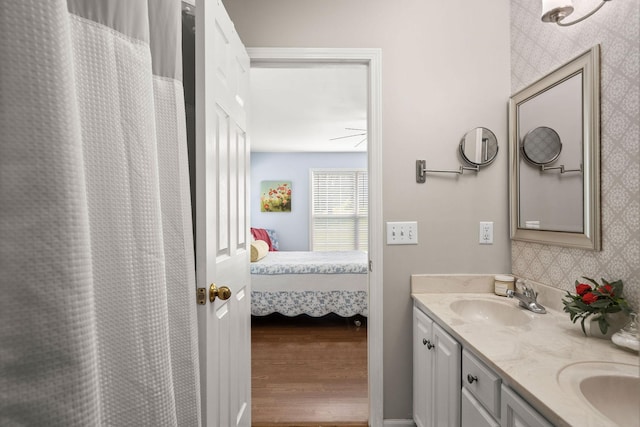 4291 Skelley Rd, Santa Fe, TN 38482 - ensuite bathroom featuring double vanity, wood finished floors, and decorative backsplash