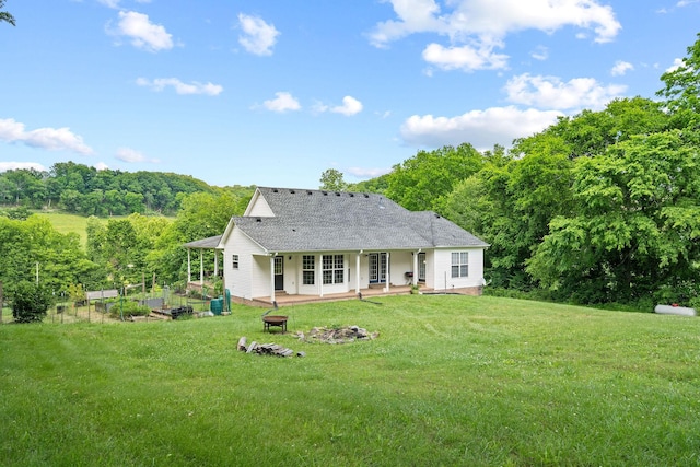 4291 Skelley Rd, Santa Fe, TN 38482 - rear view of property featuring a yard, a shingled roof, a patio area, and an outdoor fire pit