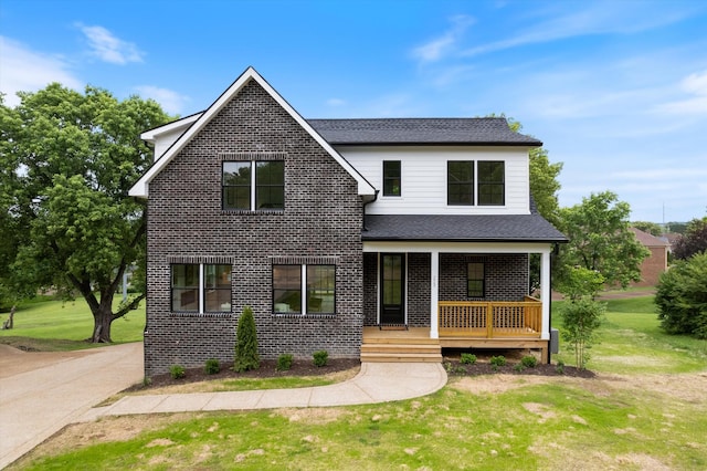 229 Cambridge Pl, Franklin, TN 37067 - view of front of property featuring covered porch, brick siding, and a front lawn