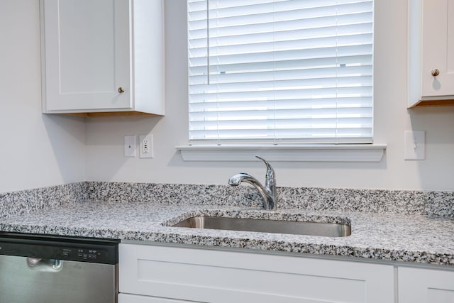 1003 Autumnwood Dr, Dickson, TN 37055 - kitchen with stainless steel dishwasher, white cabinets, and light stone countertops