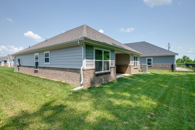 1003 Autumnwood Dr, Dickson, TN 37055 - back of house featuring brick siding and a shingled roof