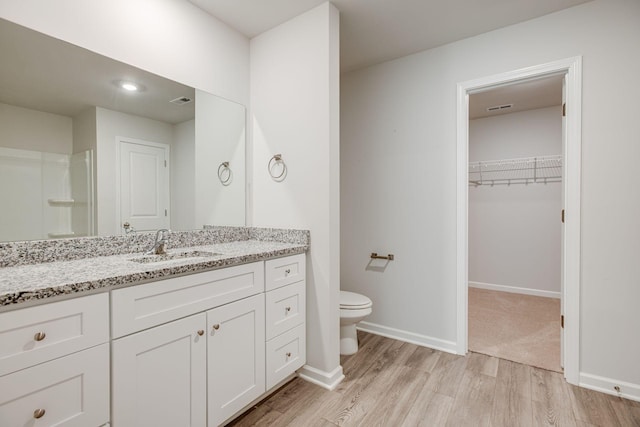 1003 Autumnwood Dr, Dickson, TN 37055 - bathroom featuring wood finished floors, vanity, and a walk in closet