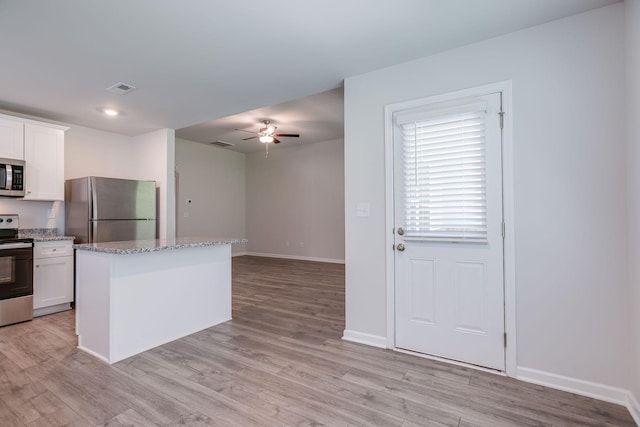 1003 Autumnwood Dr, Dickson, TN 37055 - kitchen with stainless steel appliances, ceiling fan, light wood-type flooring, and white cabinets