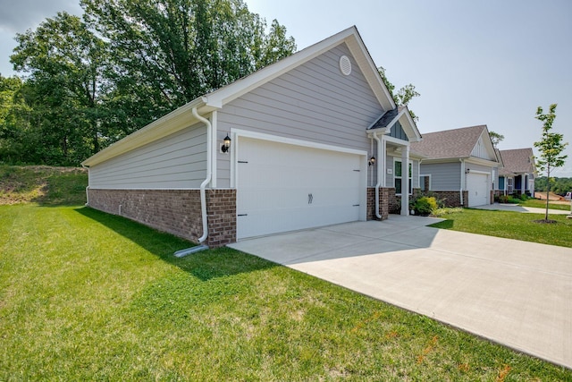 1003 Autumnwood Dr, Dickson, TN 37055 - view of home's exterior with brick siding, a lawn, an attached garage, and concrete driveway