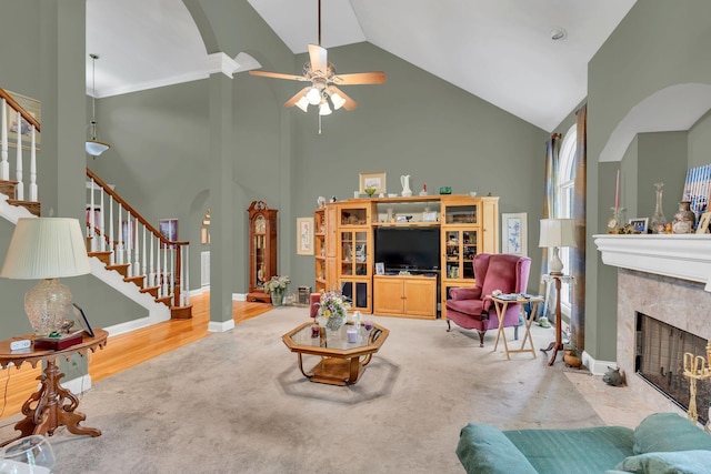 4090 Ironwood Dr, Greenbrier, TN 37073 - living area featuring arched walkways, high vaulted ceiling, stairs, a premium fireplace, and a ceiling fan