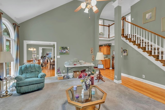 4090 Ironwood Dr, Greenbrier, TN 37073 - carpeted living area featuring high vaulted ceiling, plenty of natural light, a ceiling fan, stairs, and baseboards