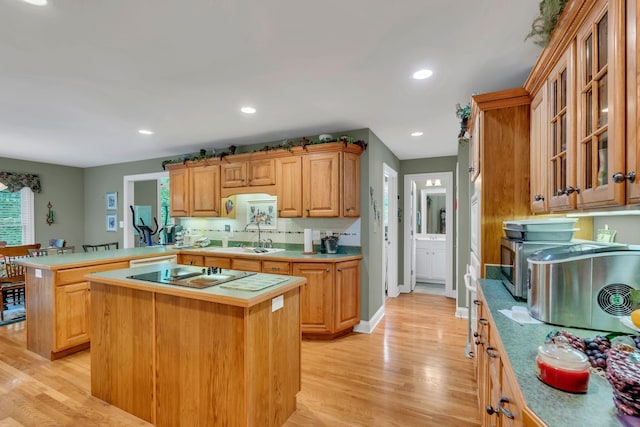 4090 Ironwood Dr, Greenbrier, TN 37073 - kitchen featuring black electric stovetop, a sink, light wood finished floors, light countertops, and recessed lighting