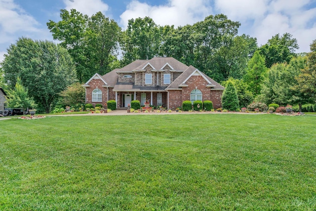 4090 Ironwood Dr, Greenbrier, TN 37073 - craftsman-style house featuring a front lawn, brick siding, and covered porch