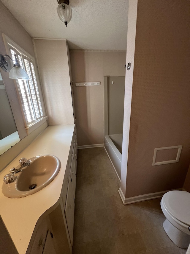 212 N 3rd St, Pulaski, TN 38478 - bathroom featuring vanity, toilet, a textured ceiling, baseboards, and washtub / shower combination