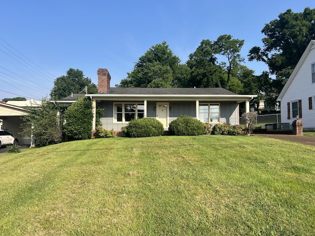 212 N 3rd St, Pulaski, TN 38478 - view of front facade with board and batten siding, a chimney, and a front yard