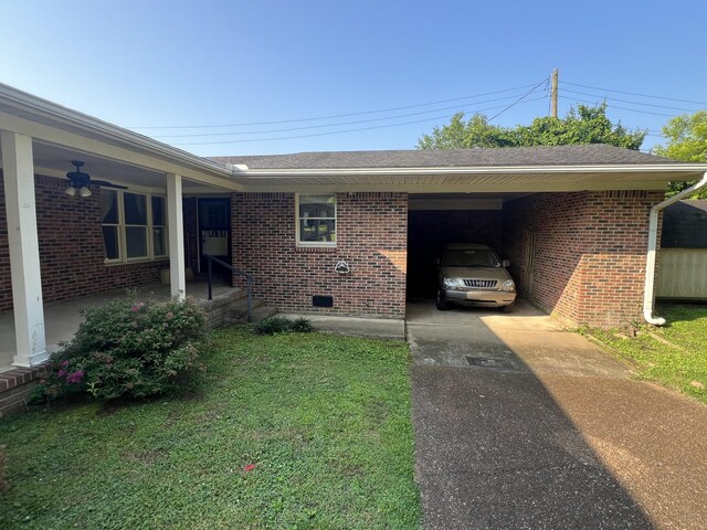 212 N 3rd St, Pulaski, TN 38478 - view of home's exterior with driveway, brick siding, an attached carport, and a yard