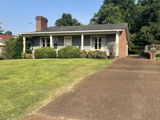 212 N 3rd St, Pulaski, TN 38478 - view of front facade featuring a chimney, a front lawn, board and batten siding, and a shingled roof