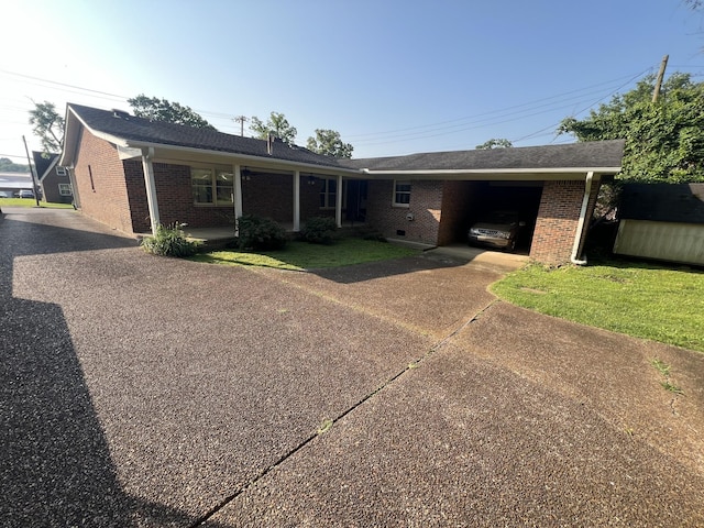 212 N 3rd St, Pulaski, TN 38478 - ranch-style house with asphalt driveway, brick siding, and an attached carport
