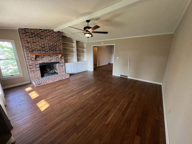 212 N 3rd St, Pulaski, TN 38478 - unfurnished living room with wood-type flooring, baseboards, a brick fireplace, a textured ceiling, and ceiling fan