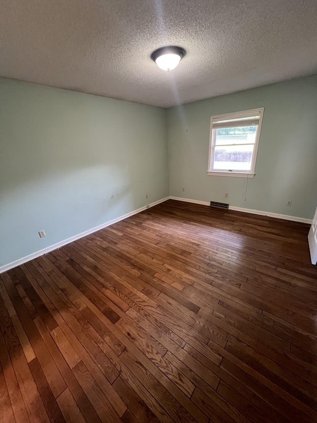 212 N 3rd St, Pulaski, TN 38478 - unfurnished room featuring dark wood-style floors, a textured ceiling, and baseboards