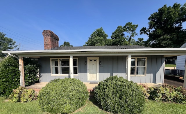 212 N 3rd St, Pulaski, TN 38478 - view of front of house featuring a chimney, a porch, and board and batten siding