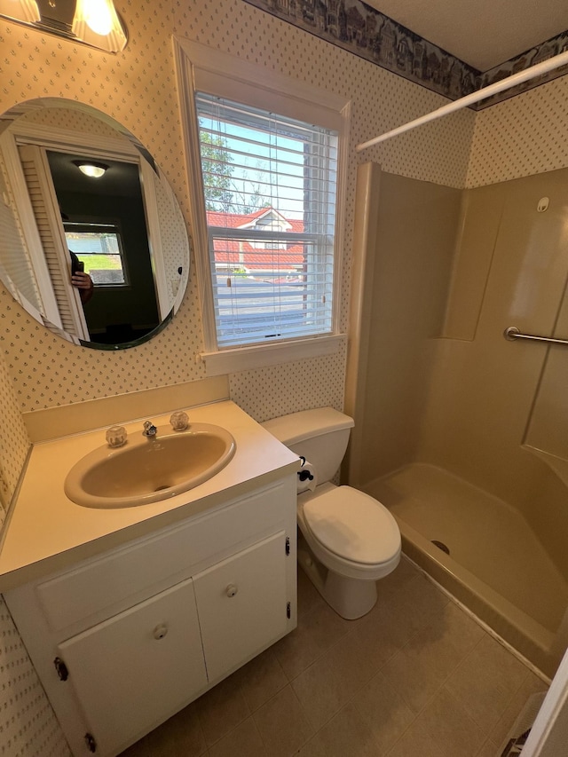 212 N 3rd St, Pulaski, TN 38478 - full bathroom with wallpapered walls, a shower, vanity, toilet, and tile patterned flooring