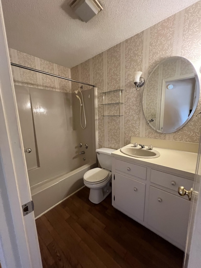 212 N 3rd St, Pulaski, TN 38478 - full bath with wallpapered walls, shower / washtub combination, wood finished floors, a textured ceiling, and vanity