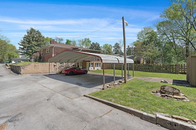 1618 Woodside Dr, Lebanon, TN 37087 - view of parking featuring driveway, a carport, and an outdoor fire pit