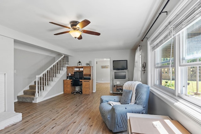 1618 Woodside Dr, Lebanon, TN 37087 - living area featuring light wood-style flooring, a ceiling fan, stairs, a desk, and baseboards