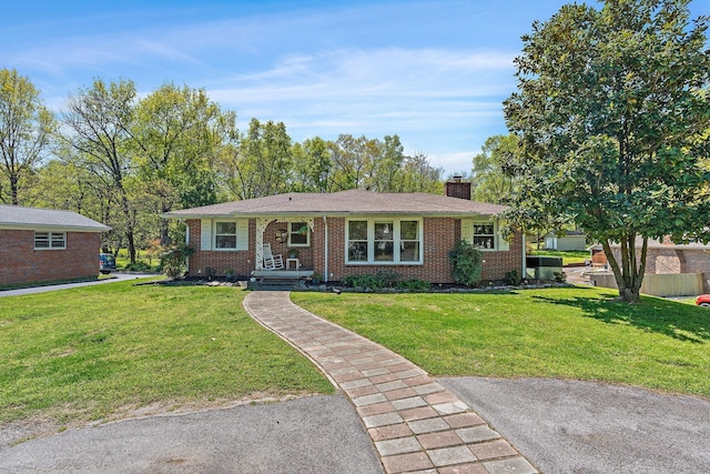 1618 Woodside Dr, Lebanon, TN 37087 - view of front of property featuring brick siding, a front yard, and a chimney