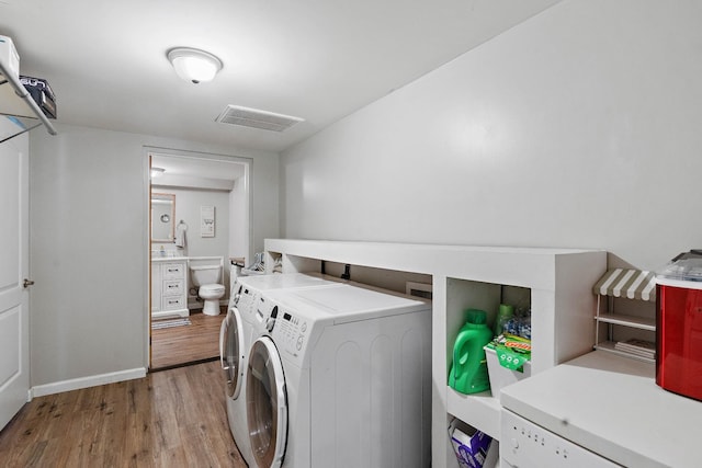 1618 Woodside Dr, Lebanon, TN 37087 - laundry room featuring independent washer and dryer, light wood-style flooring, and baseboards