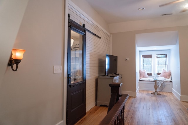 205 College St, Portland, TN 37148 - corridor with hardwood / wood-style floors, a barn door, and baseboards