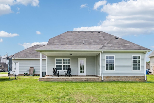 4219 Zephyr Ct, Murfreesboro, TN 37128 - back of house with a trampoline, a lawn, a patio area, and a shingled roof