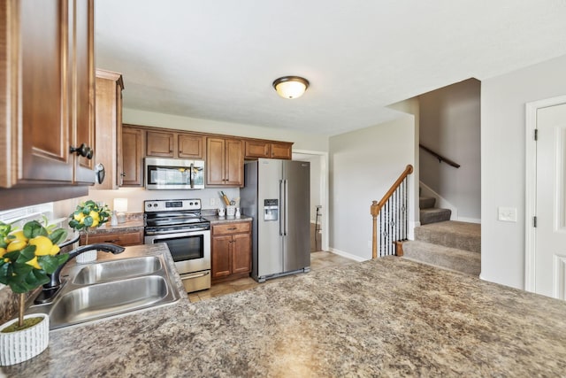 4219 Zephyr Ct, Murfreesboro, TN 37128 - kitchen with appliances with stainless steel finishes, a sink, brown cabinetry, light tile patterned flooring, and baseboards