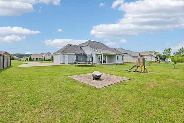 4219 Zephyr Ct, Murfreesboro, TN 37128 - rear view of property featuring a trampoline, a playground, a yard, driveway, and an outdoor fire pit