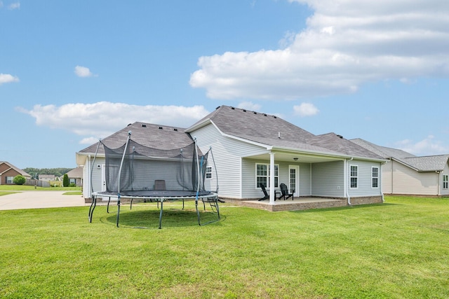 4219 Zephyr Ct, Murfreesboro, TN 37128 - rear view of house featuring a patio area, a trampoline, and a lawn