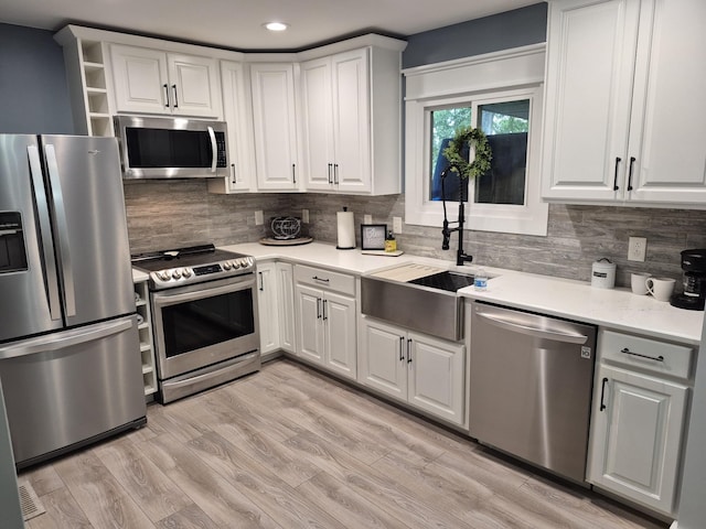 1140 Morriswood Dr, Joelton, TN 37080 - kitchen with appliances with stainless steel finishes, a sink, tasteful backsplash, light countertops, and recessed lighting