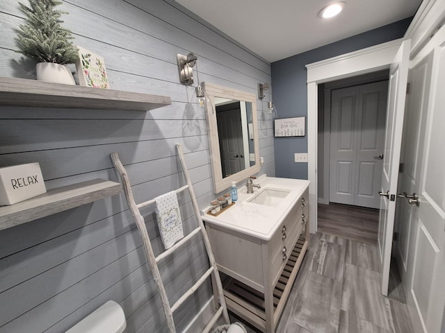 1140 Morriswood Dr, Joelton, TN 37080 - half bath featuring wood walls, vanity, toilet, recessed lighting, and wood finished floors