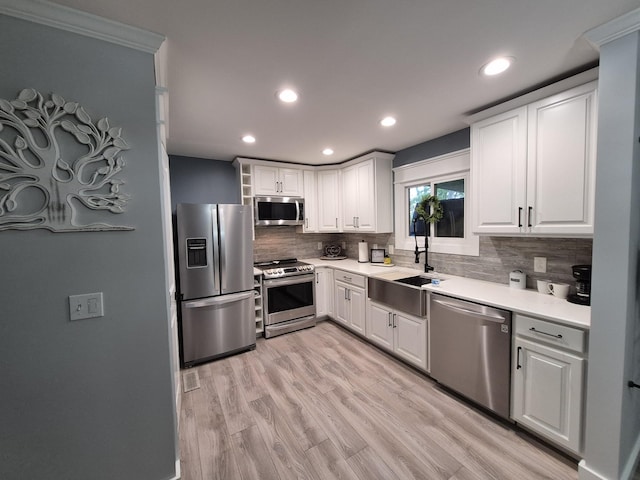 1140 Morriswood Dr, Joelton, TN 37080 - kitchen with stainless steel appliances, a sink, recessed lighting, decorative backsplash, and light countertops