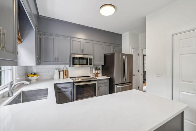 907 Paddock Park, Nashville, TN 37220 - kitchen featuring appliances with stainless steel finishes, a sink, backsplash, and light countertops