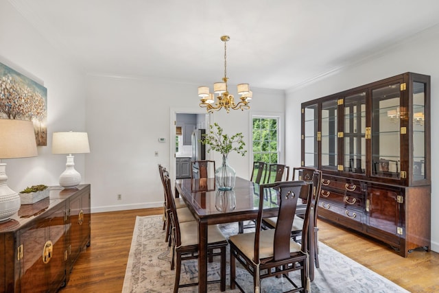 907 Paddock Park, Nashville, TN 37220 - dining space featuring a chandelier, crown molding, wood finished floors, and baseboards