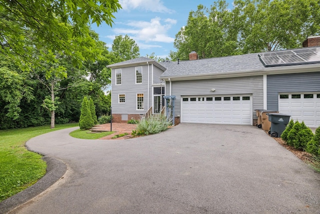 907 Paddock Park, Nashville, TN 37220 - view of front of home with driveway, a chimney, an attached garage, roof with shingles, and solar panels