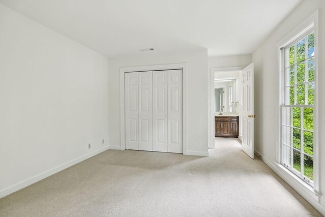 907 Paddock Park, Nashville, TN 37220 - unfurnished bedroom with light colored carpet, baseboards, and a closet