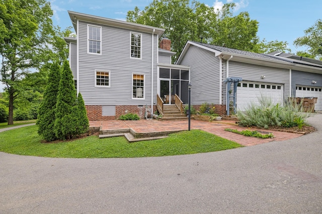 907 Paddock Park, Nashville, TN 37220 - view of front facade with a sunroom, an attached garage, and a front yard