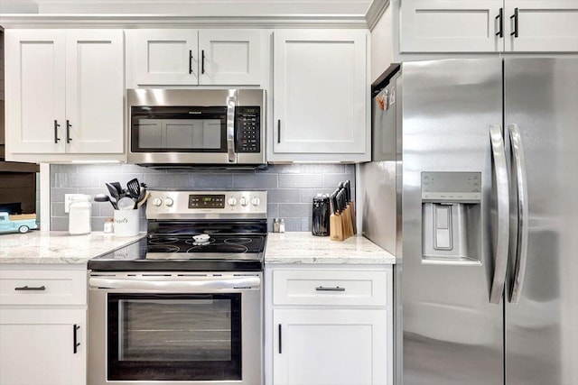 3128 Crow Rd NE, Dalton, GA 30721 - kitchen featuring stainless steel appliances, tasteful backsplash, white cabinetry, and light stone counters