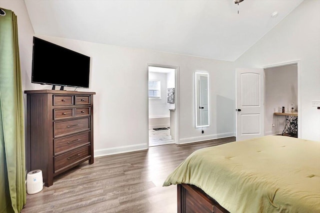 3128 Crow Rd NE, Dalton, GA 30721 - bedroom featuring vaulted ceiling, wood finished floors, baseboards, and ensuite bath