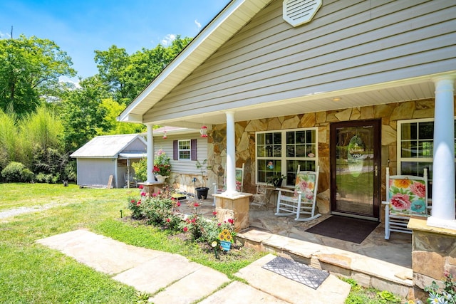 222 Bennie Camp Rd, Dunlap, TN 37327 - view of exterior entry featuring stone siding, covered porch, and a yard
