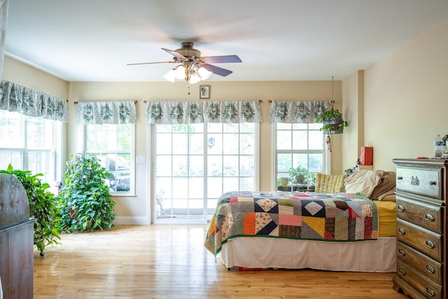 222 Bennie Camp Rd, Dunlap, TN 37327 - bedroom with multiple windows, wood finished floors, and access to outside