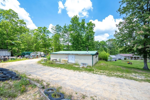 222 Bennie Camp Rd, Dunlap, TN 37327 - view of front facade with metal roof and an outbuilding